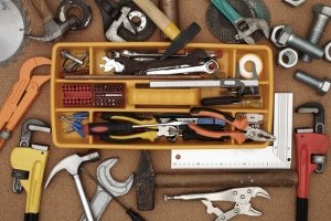 Box of tools for handyman, includes screwdrivers, spanners, hammers and rulers