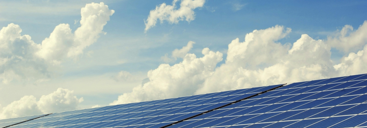 A bank of solar panels against a blue sky