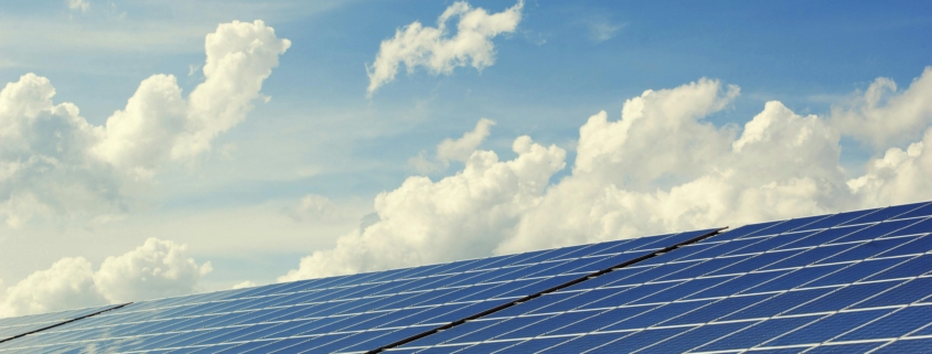 A bank of solar panels against a blue sky