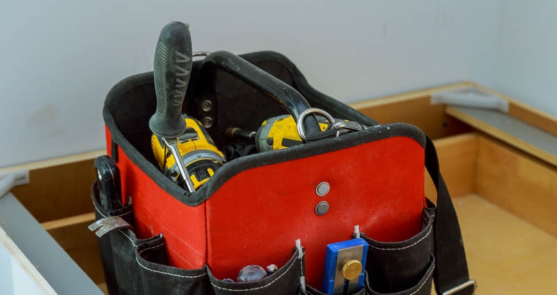 A empty tool bag with only a select few tools.